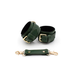 Green leather cuffs on a white background